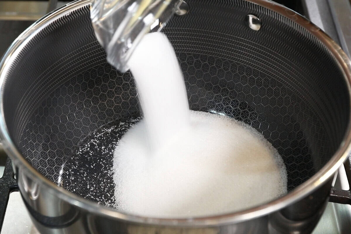 pouring sugar into pot for Vegan Matcha Crème Brûlée