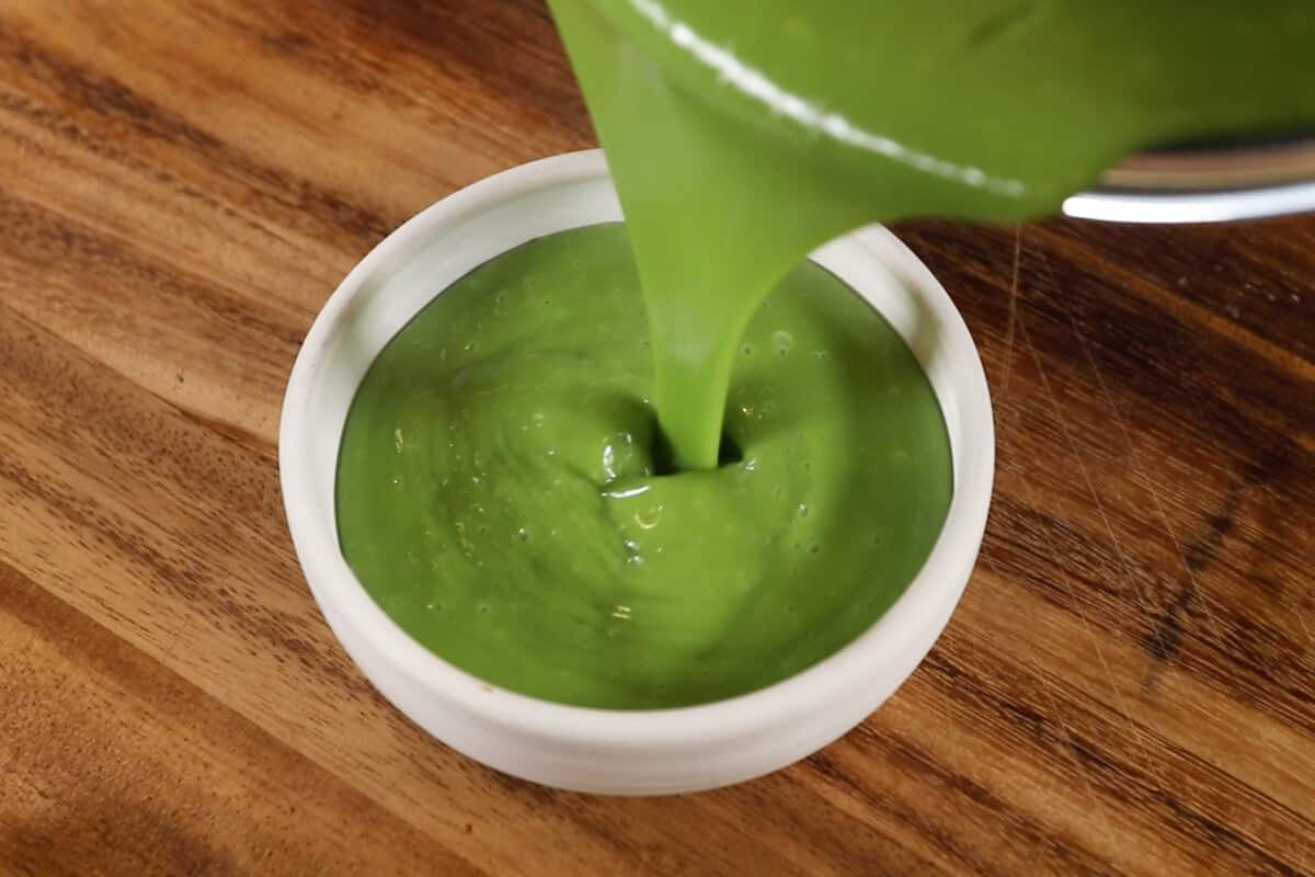 pouring matcha custard into ramekins for Vegan Matcha Crème Brûlée