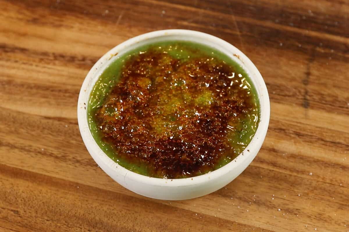 torched sugar on top of matcha custard in ramekin for Vegan Matcha Crème Brûlée