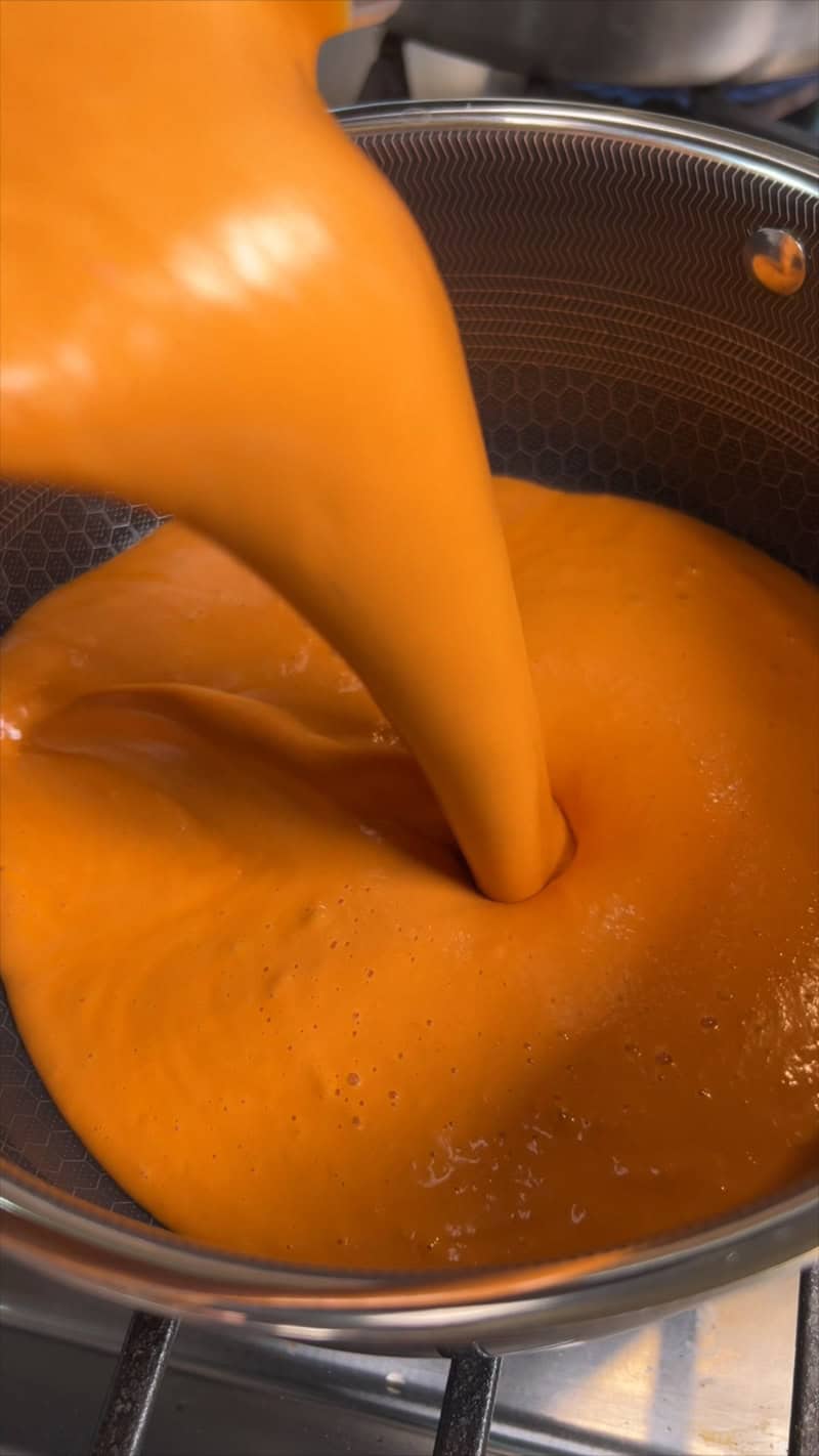 pouring sauce into a sauce pan