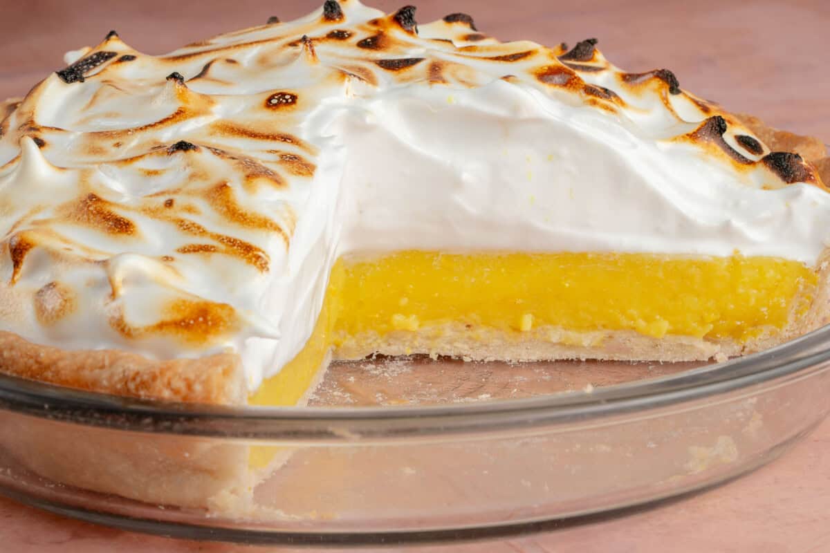 inside of a sliced vegan lemon meringue pie in glass pie pan