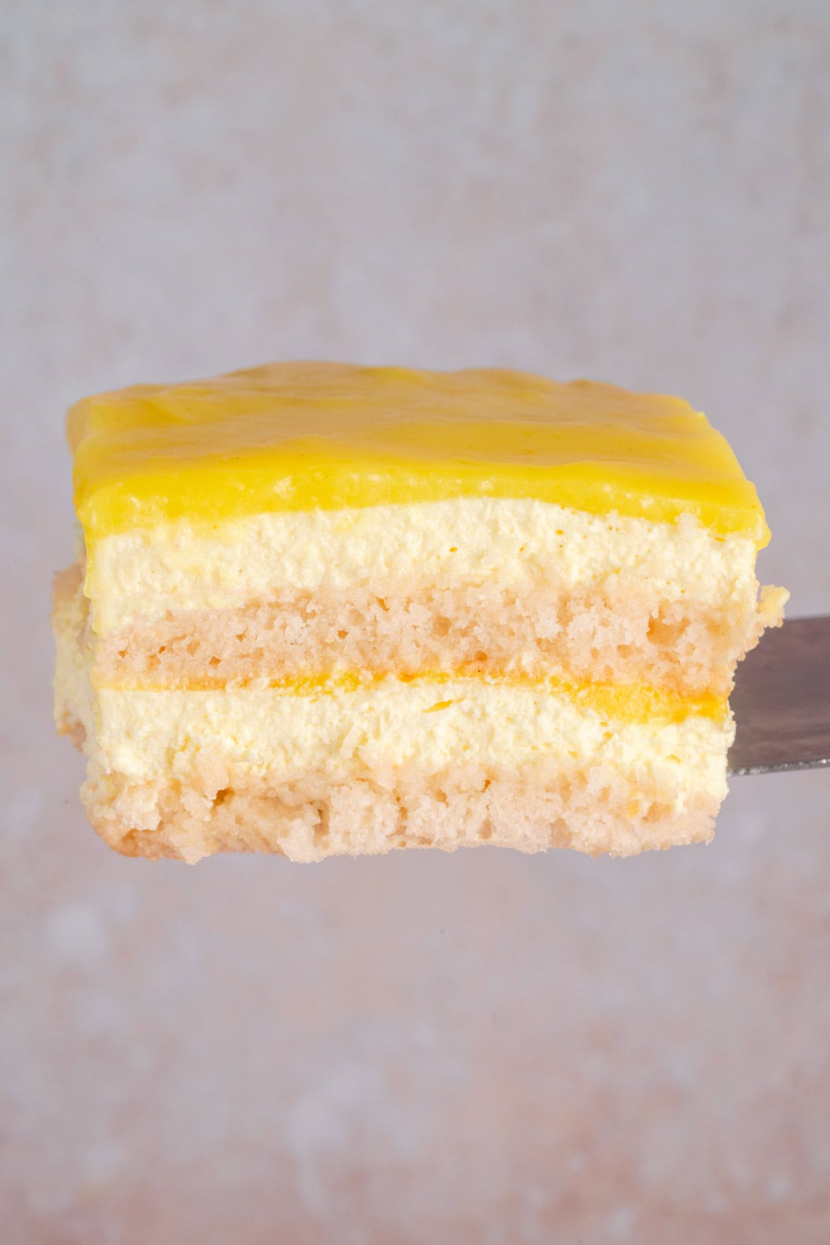 a slice of vegan limoncello tiramisu on a spatula