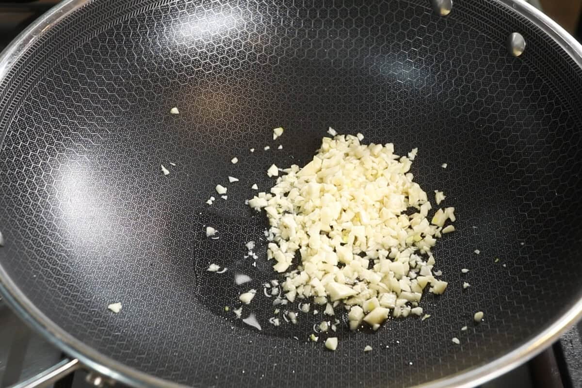 raw garlic and oil in large wok