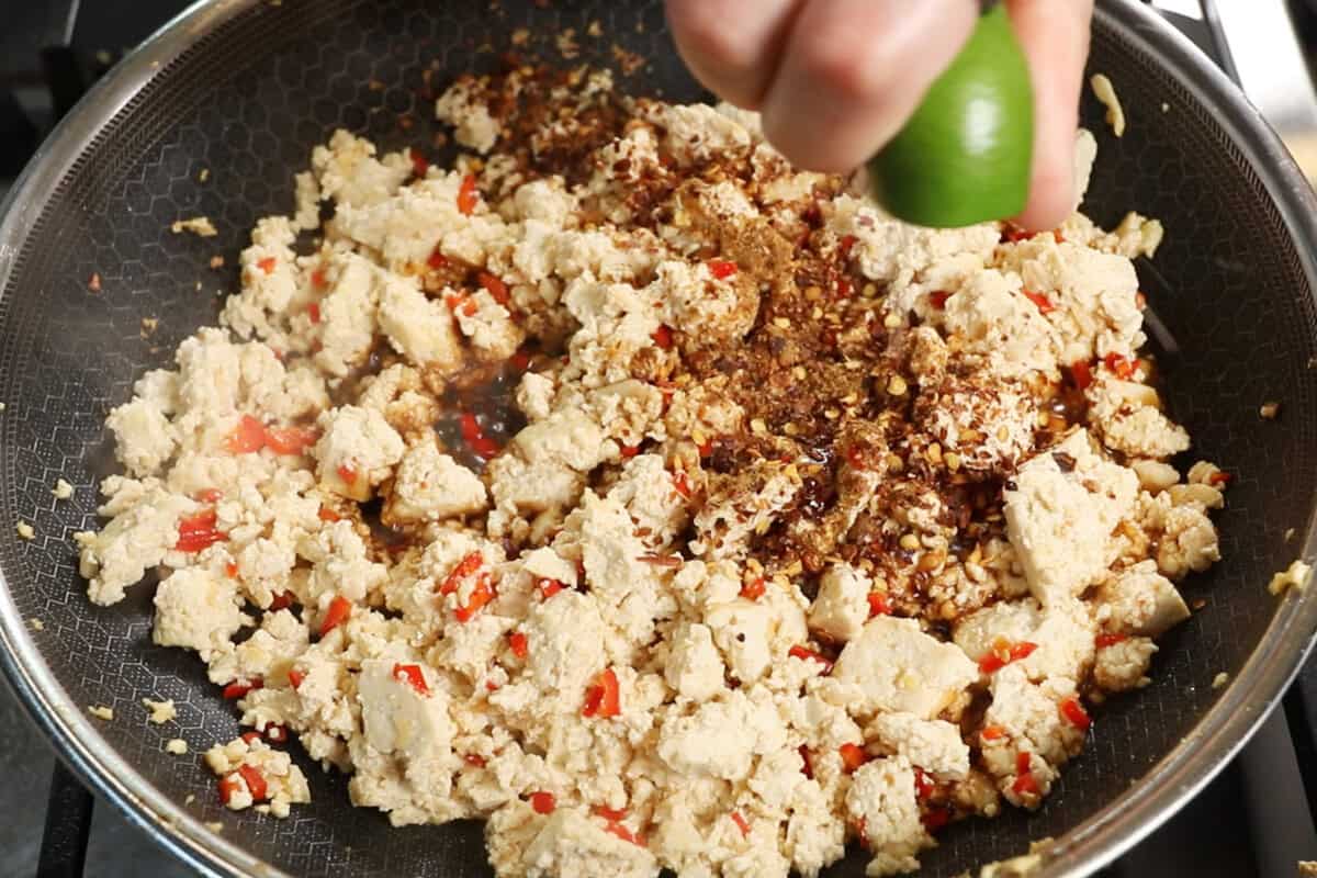 cooked tofu with spices and squeezing a lime over top