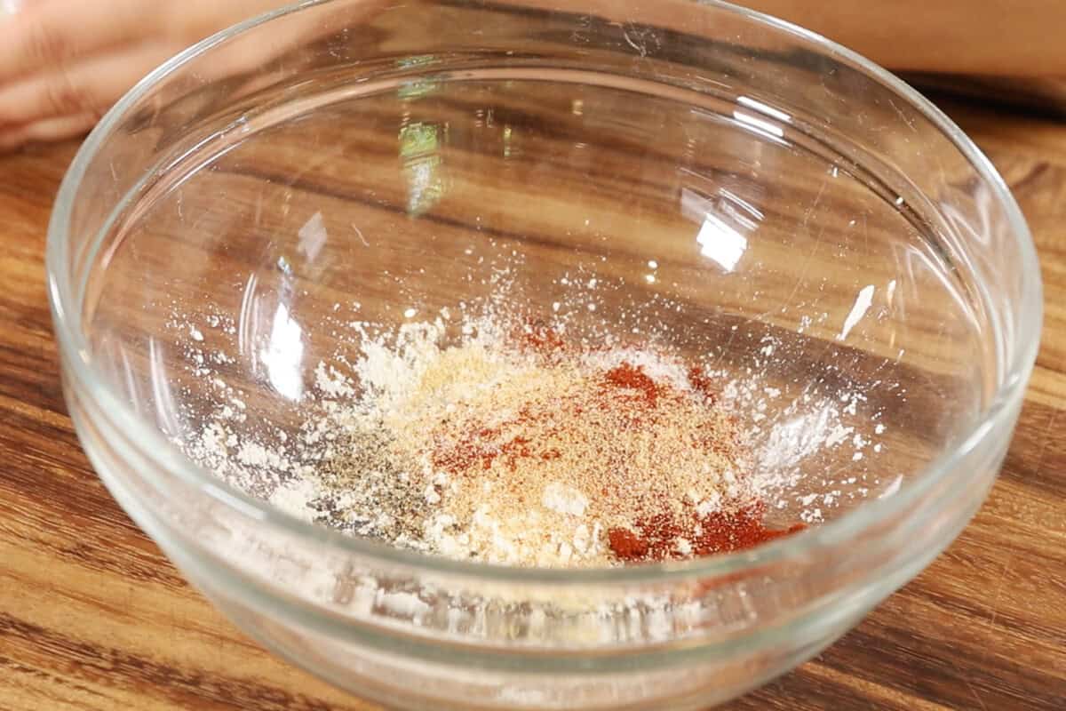 adding cornstarch and spices to a bowl