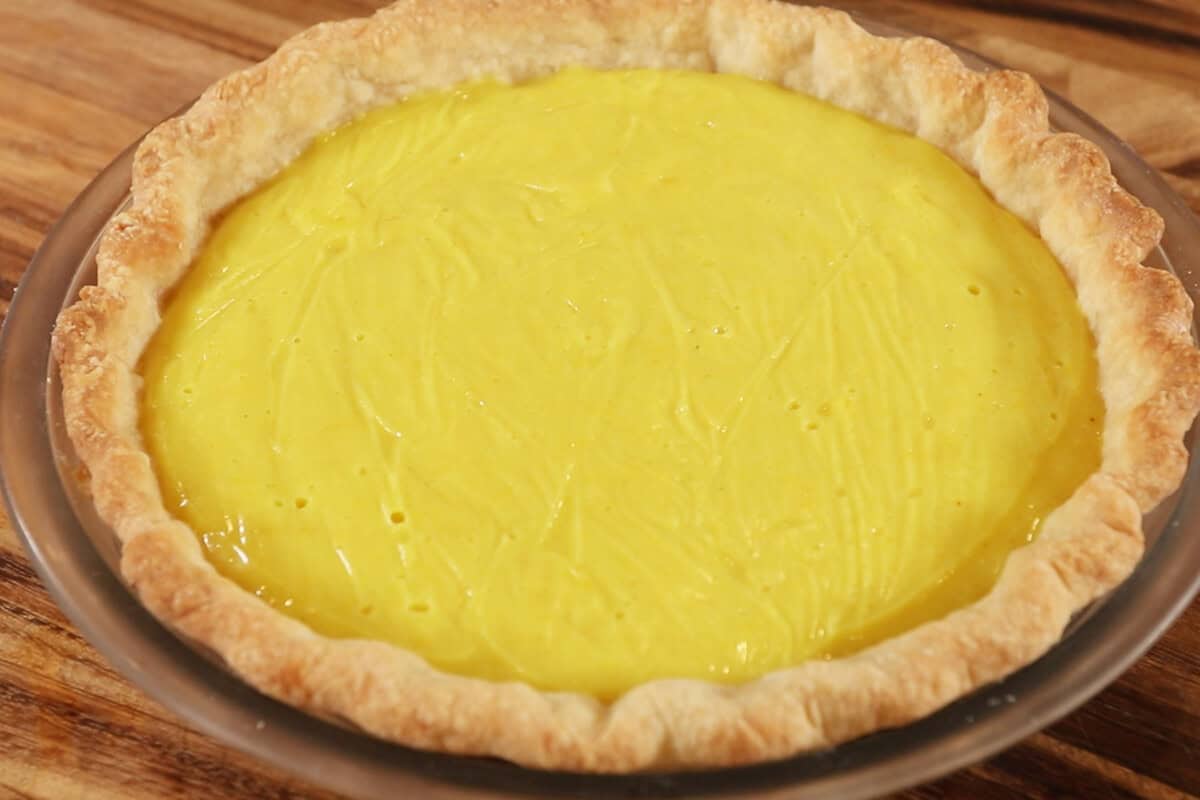 horizontal photo of a set lemon meringue pie filling before meringue is added on top