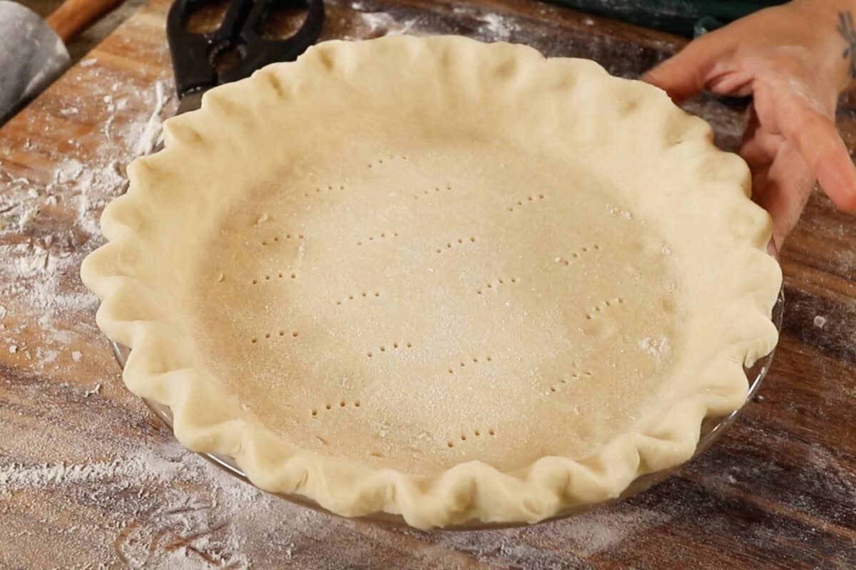 unbaked pie crust with poked holes