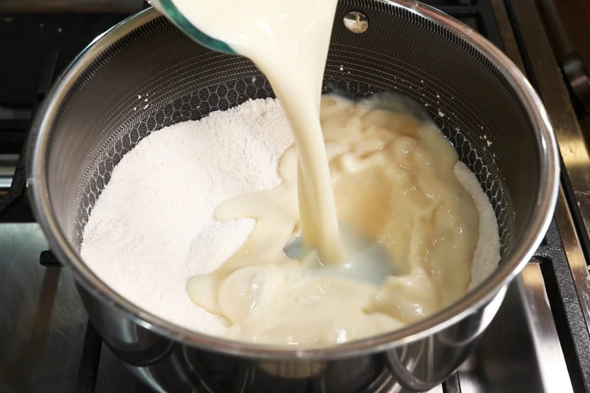 preparing lemon curd filling in small pot for Classic Vegan Lemon Meringue Pie