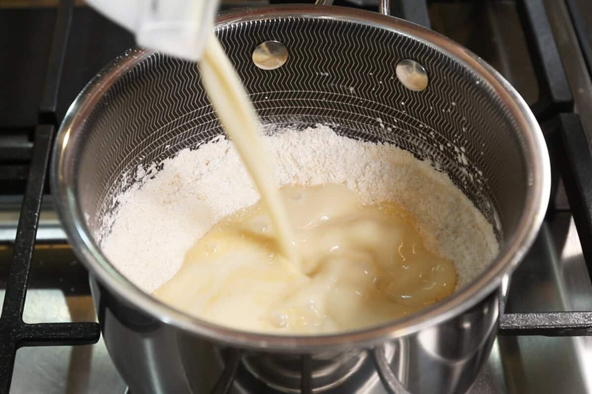 adding soy milk to saucepan