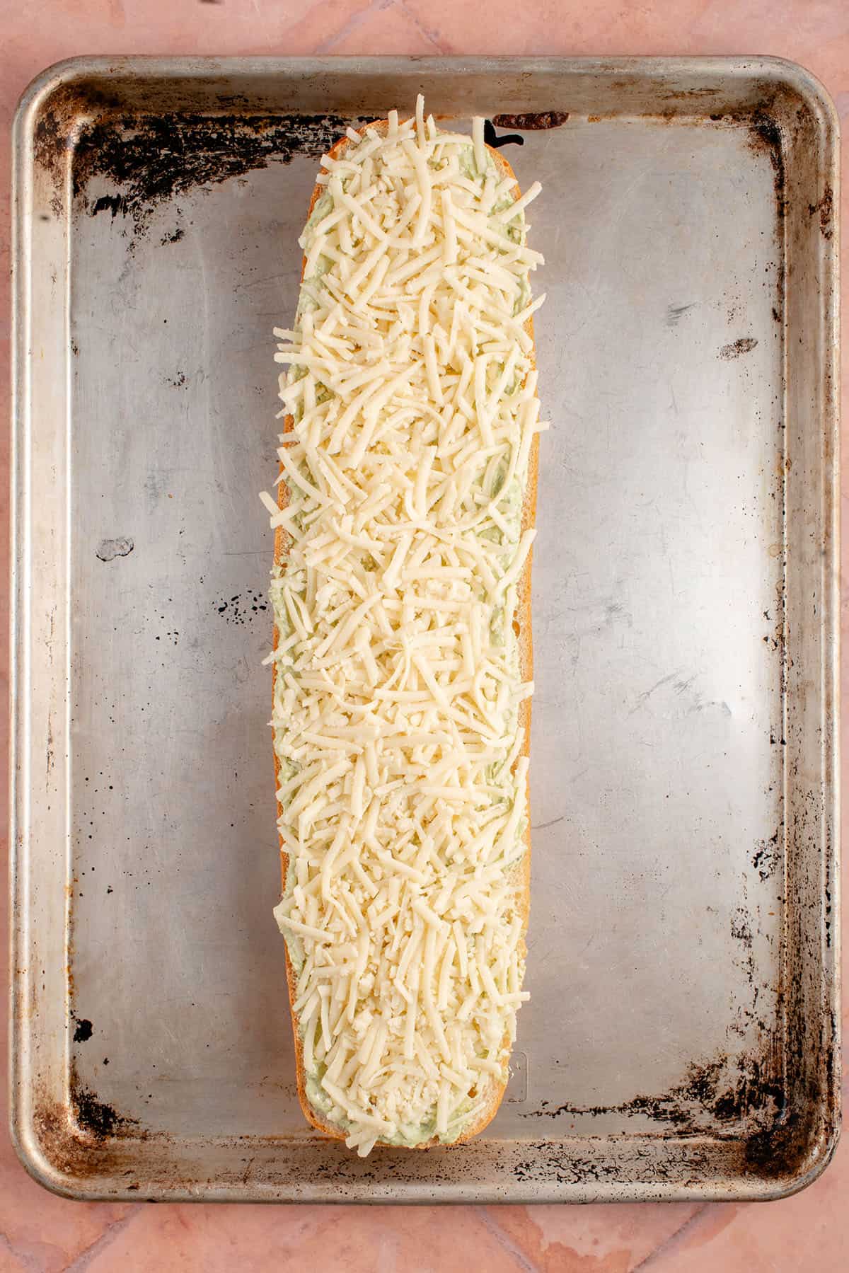 cheesy pesto garlic bread before going into the oven