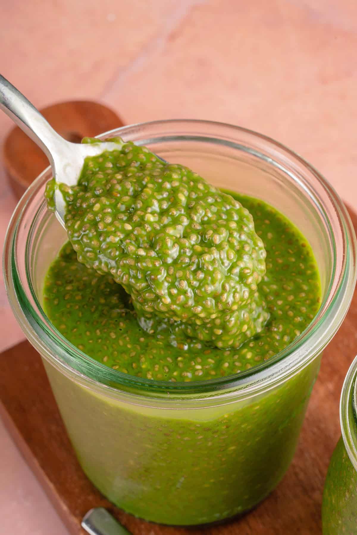 a spoonful of matcha chia pudding on top of a glass