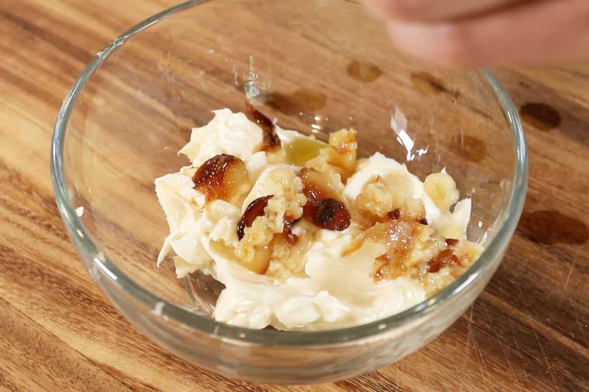 adding the roasted garlic to softened vegan butter