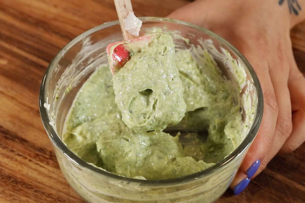 pesto garlic butter being spooned with a spatula