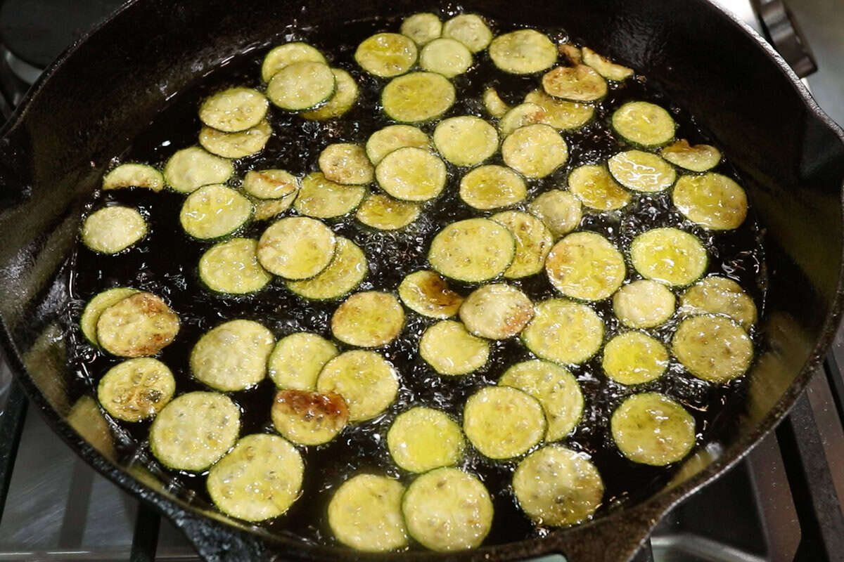 frying zucchini in a cast iron skillet