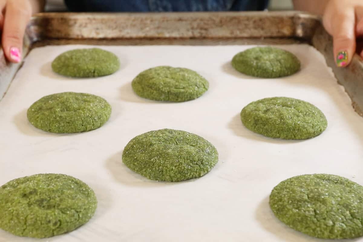 baked vegan matcha sugar cookie dough on a parchment lined baking sheet