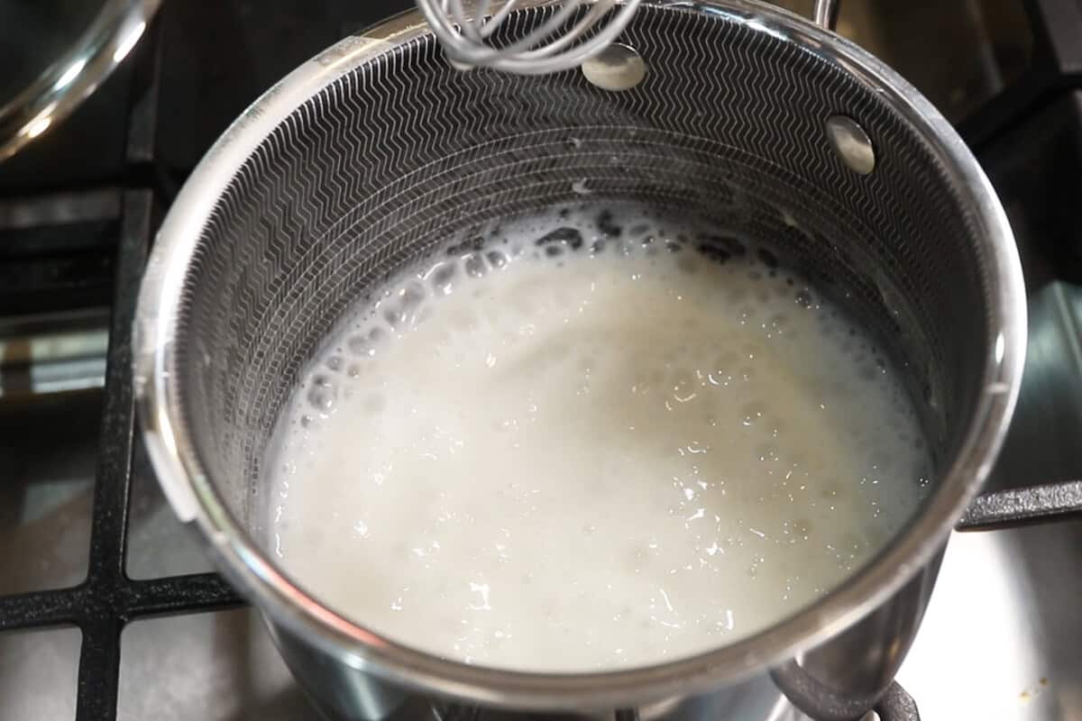 preparing sweet coconut cream sauce for mango sticky rice