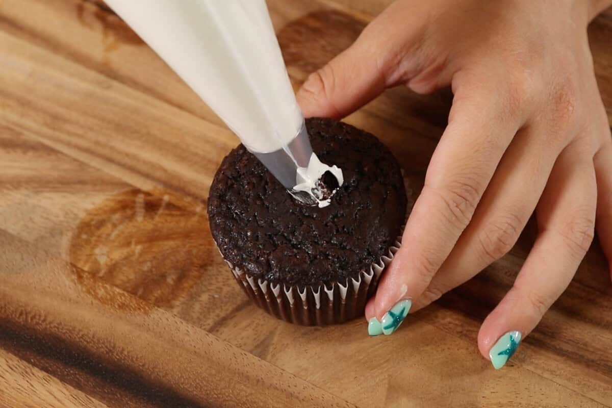 filling the cupcake with marshmallow filling