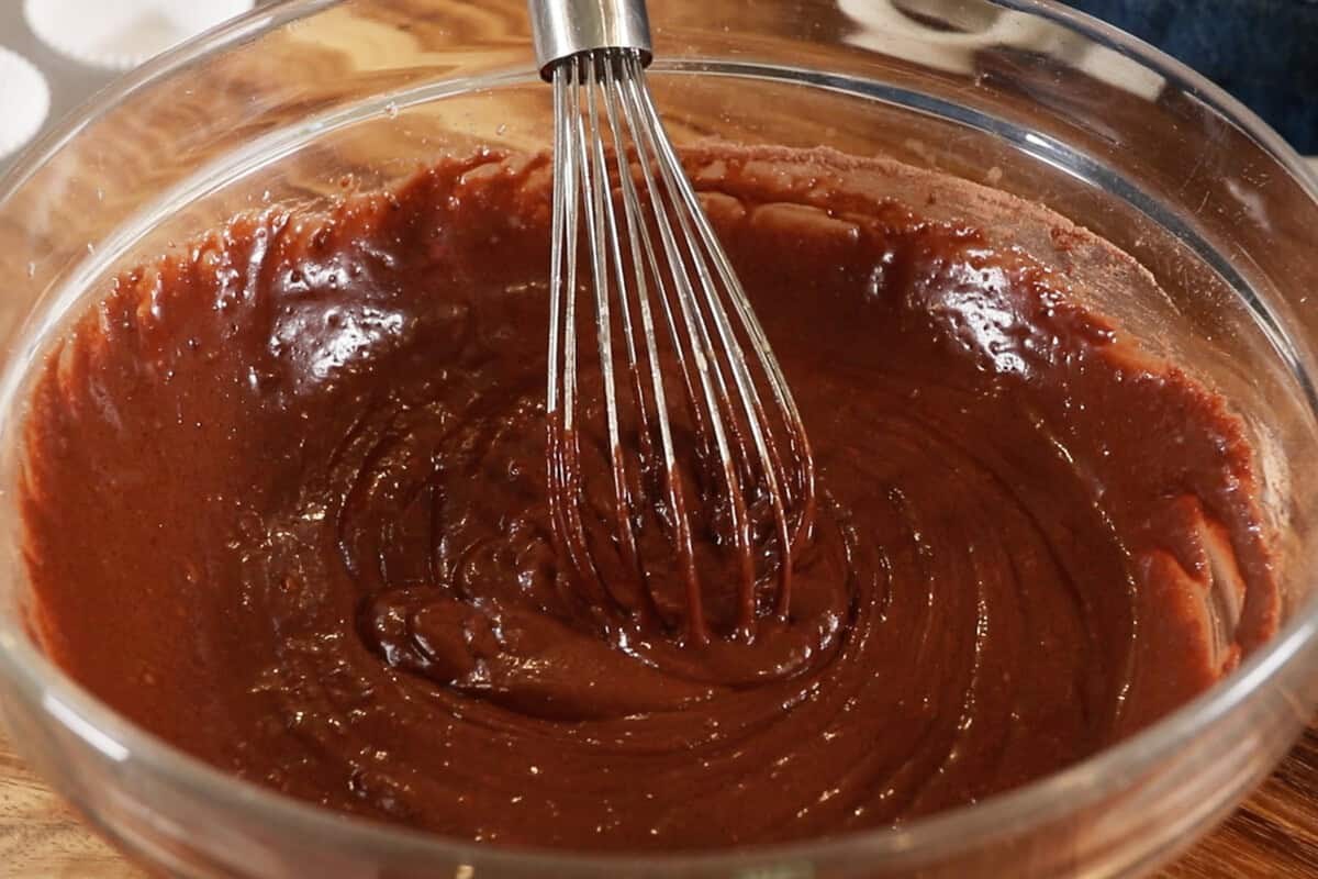 whisking the cupcake batter in a large bowl