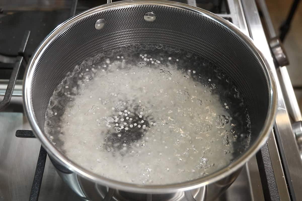 cooking tapioca pearls in boiling water for mango sago
