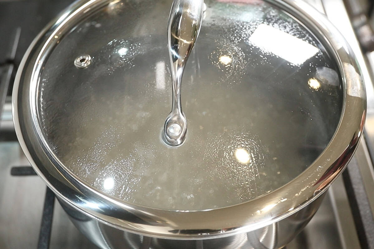 cooking tapioca pearls in boiling water for mango sago
