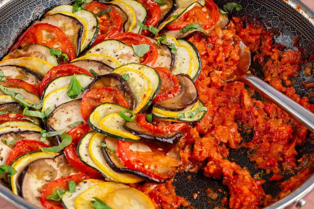 ratatouille in a pan with spoon scooping
