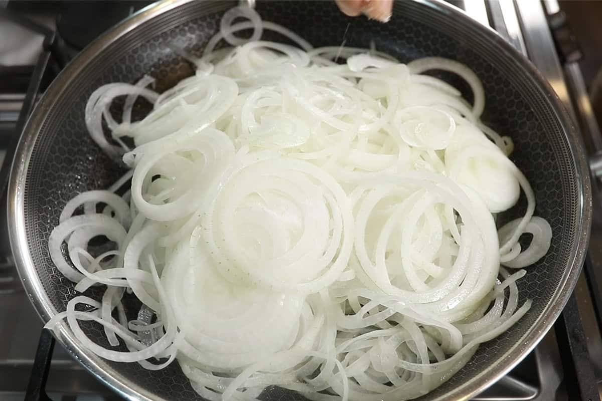 cooking down sliced onions in large skillet