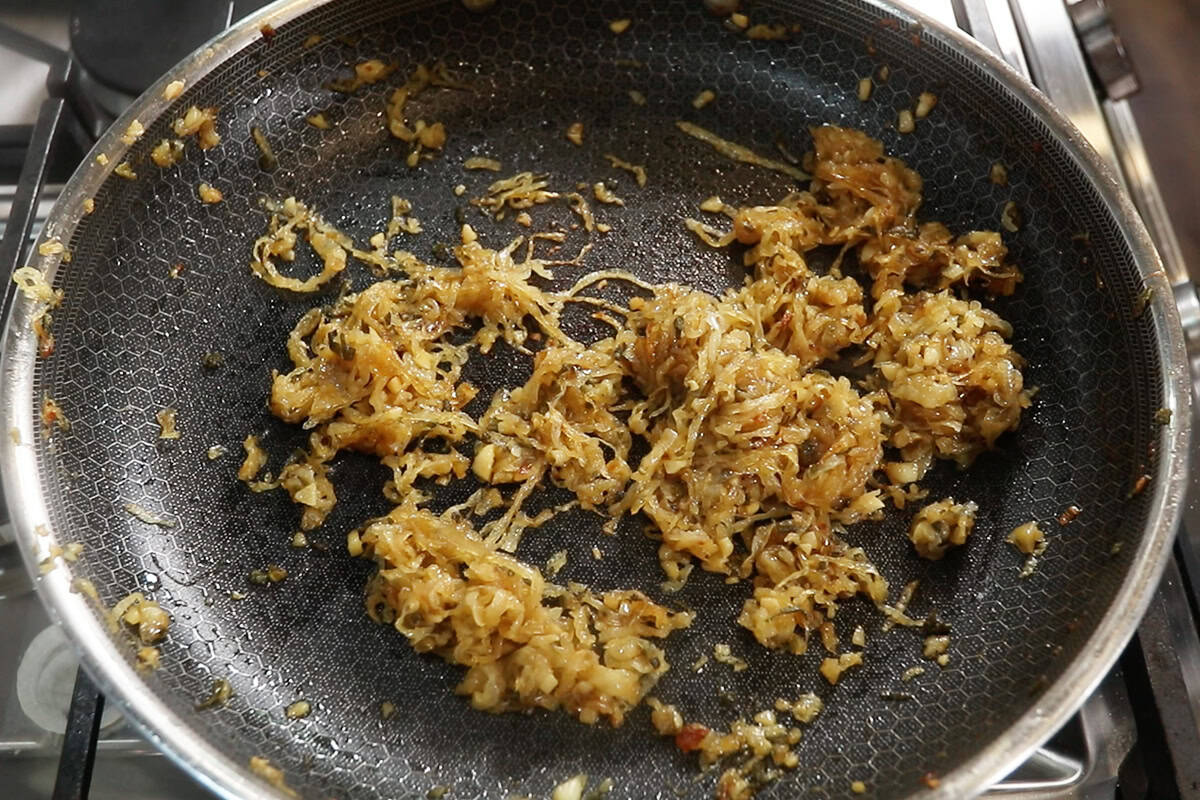caramelized onions with garlic and sage on large dark skillet