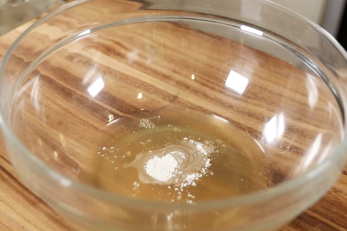 aquafaba and cream of tartar for vegan meringue in large glass bowl