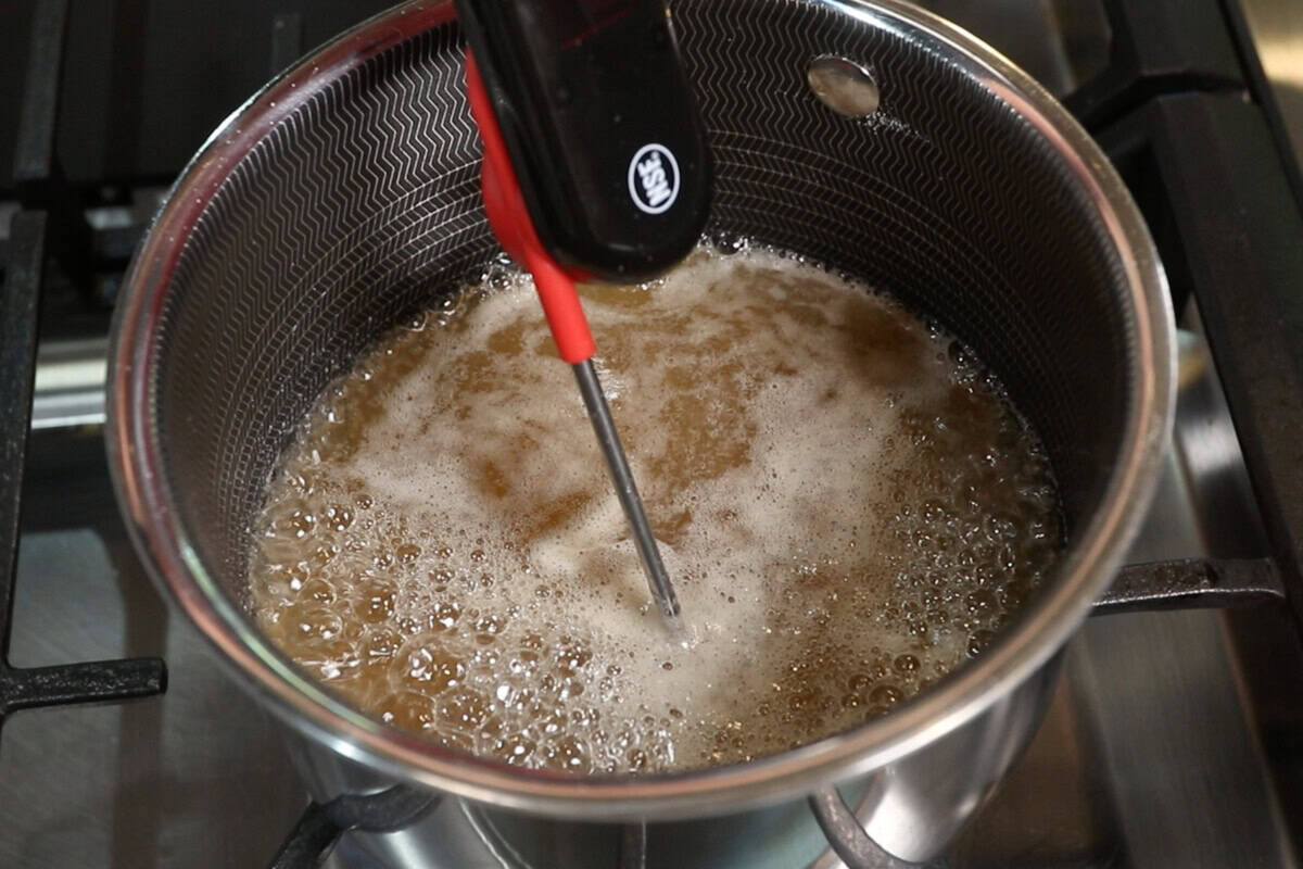 melting sugar and water in small pot with a candy thermometer