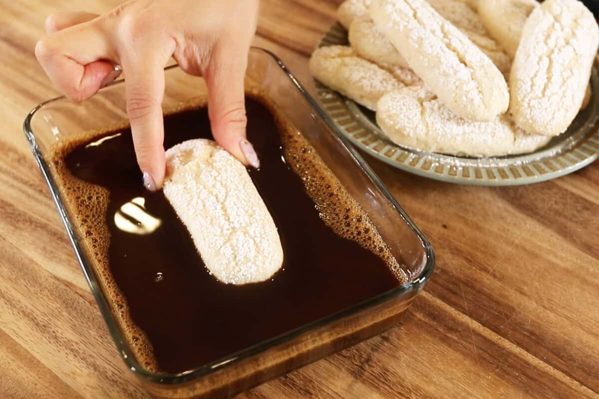 soaking lady fingers in coffee mixture