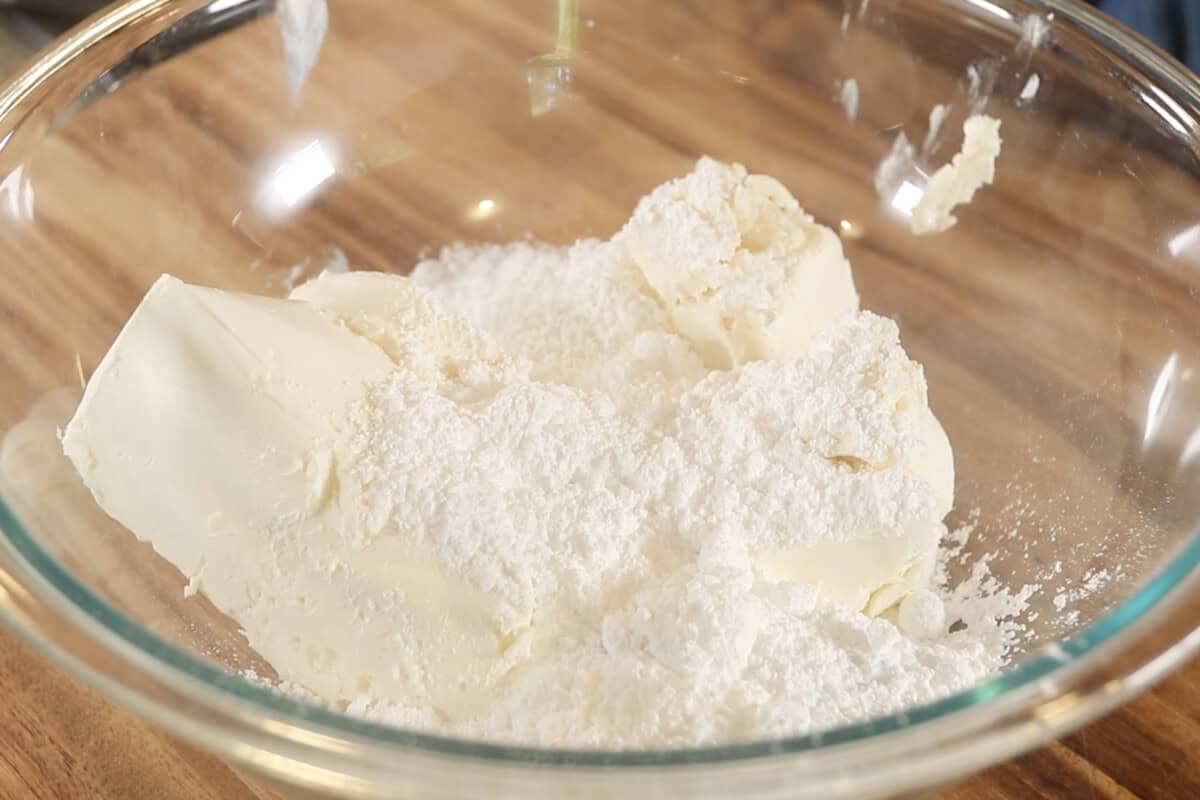 powdered sugar and cream cheese in a bowl