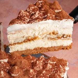 lifting a slice of tiramisu cheesecake up with spatula
