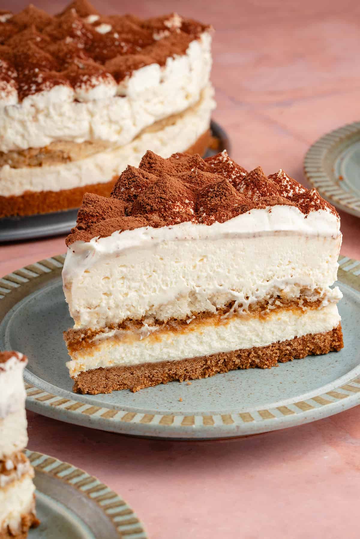 slice of tiramisu cheesecake on a blue plate with inside showing