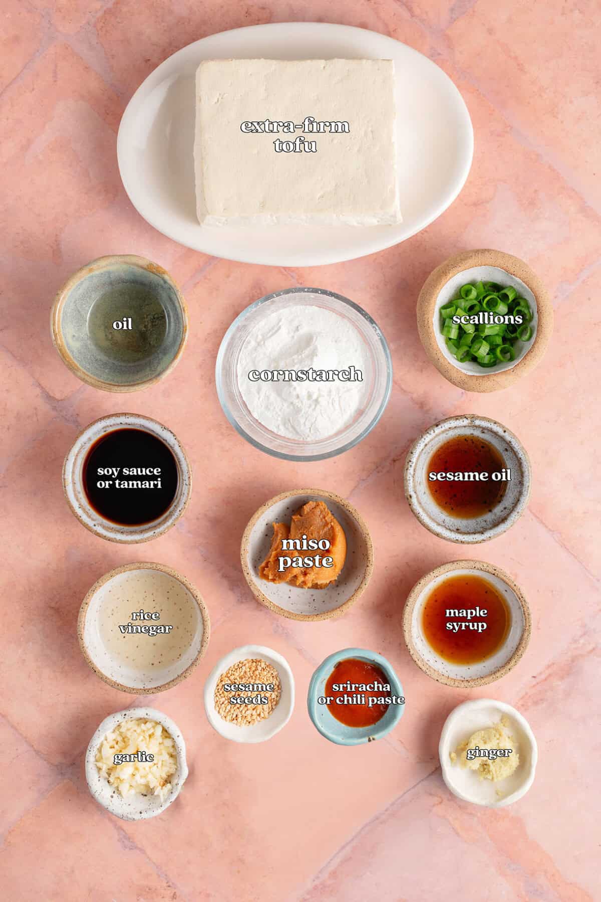 extra firm tofu, oil, cornstarch, scallions, soy sauce or tamari, sesame oil, miso pste, rice vinegar, maple syrup, sesame seeds, gsrlic, sriracha or chili paste, ginger