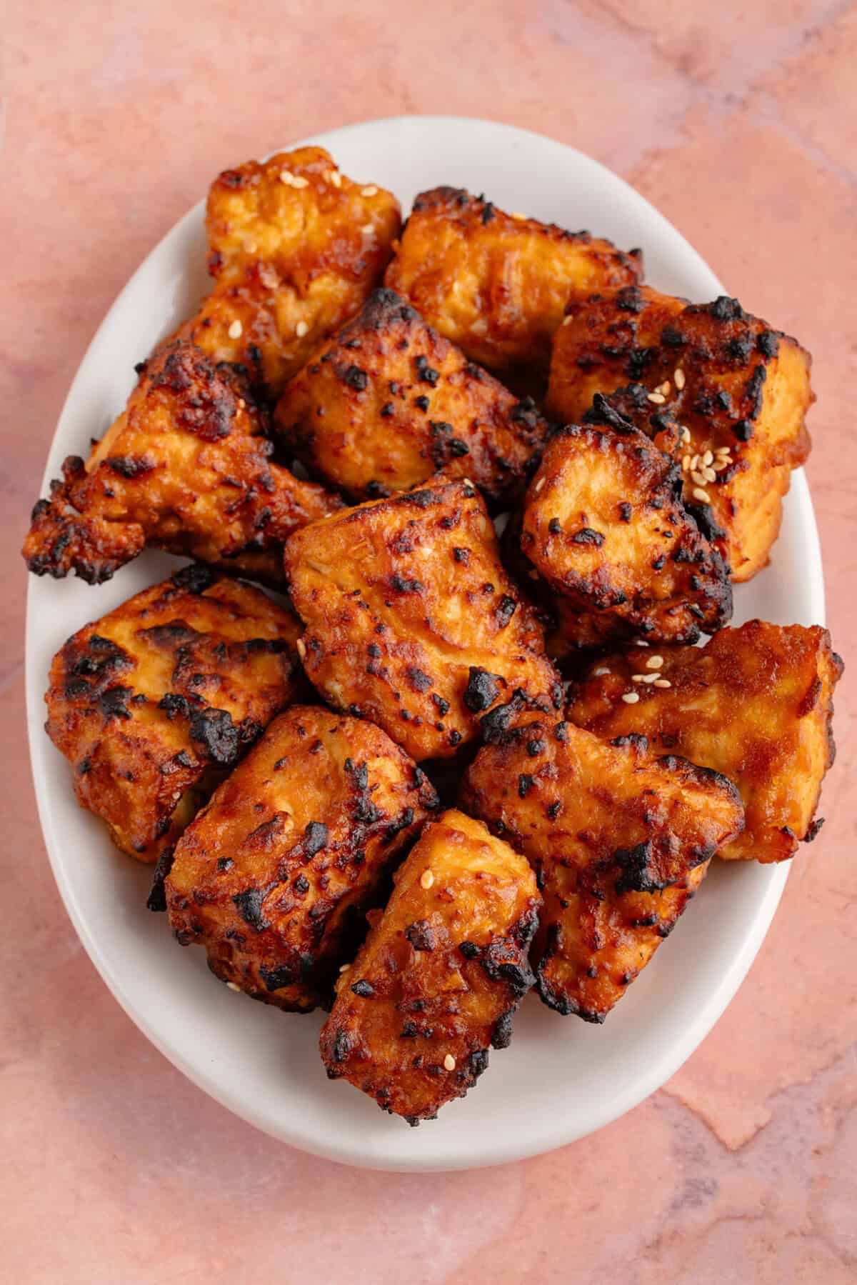 air fried miso sesame tofu piled on a plate