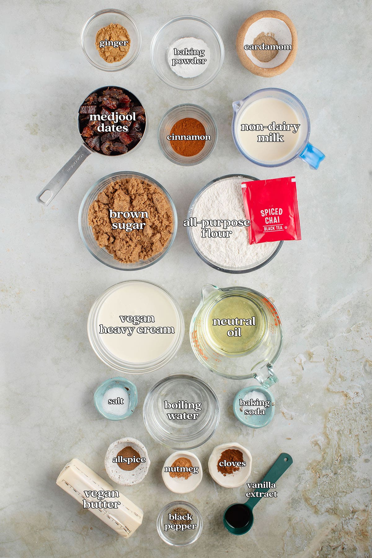 ginger, baking powder, cardamom, medjool dates, cinnamon, non-dairy milk, brown sugar, all-purpose flour, spiced chai black tea, vegan heavy cream, neutral oil, salt, boiling water, baking soda, allspice, nutmeg, cloves, vegan butter, black pepper, vanilla extract