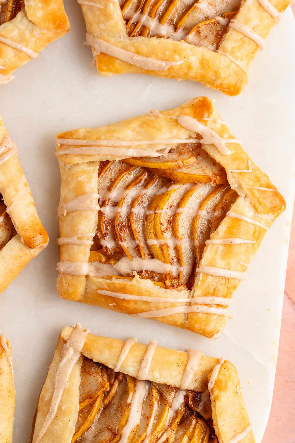 Mini Spiced Pear Galettes with maple glaze on marble board