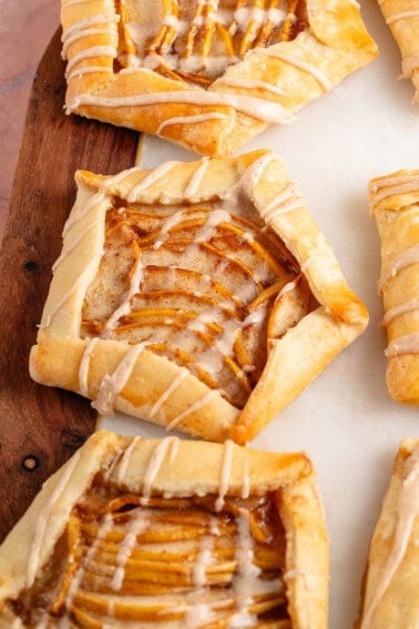 Mini Spiced Pear Galettes with maple glaze on marble and wood board
