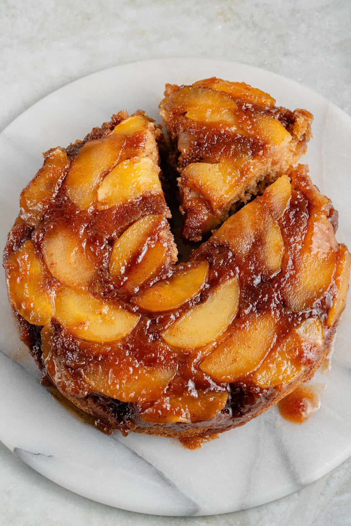 whole caramel apple upside down cake with a slice cut
