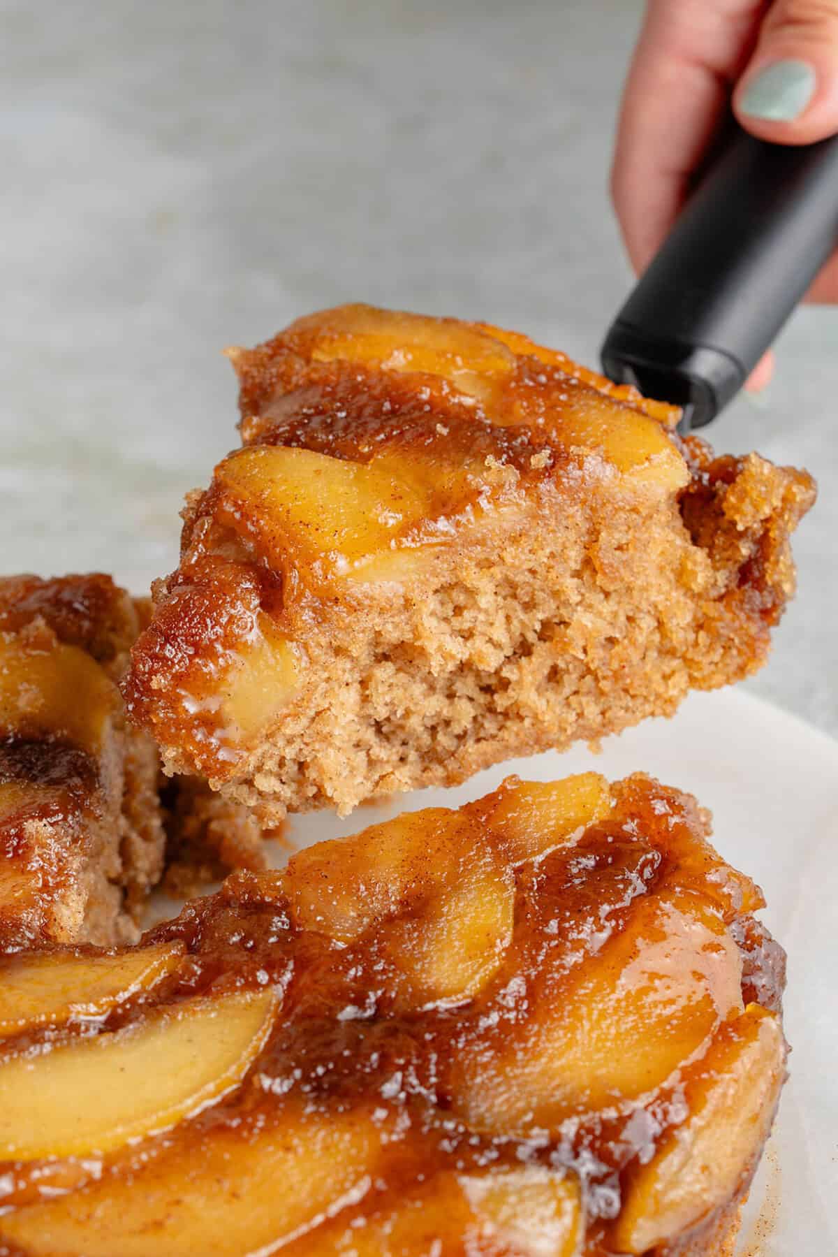 lifting a slice of caramel apple upside down cake out