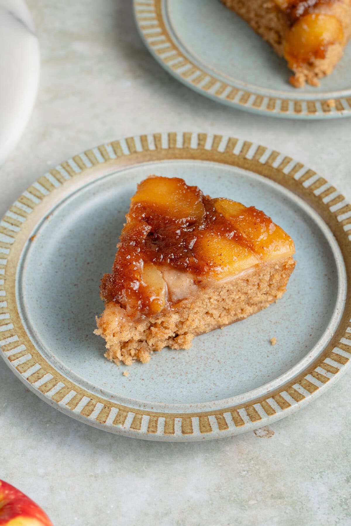 slice of vegan caramel apple upside down cake on a plate