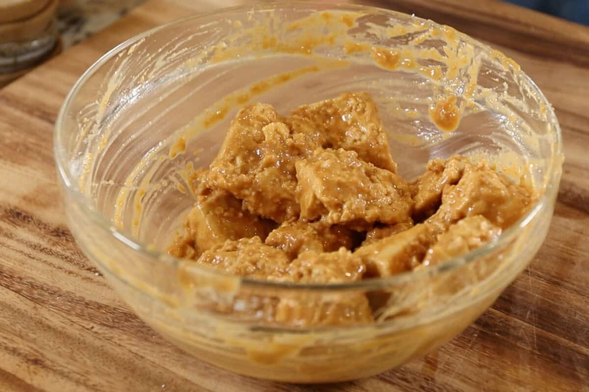 coated tofu in small bowl before air frying