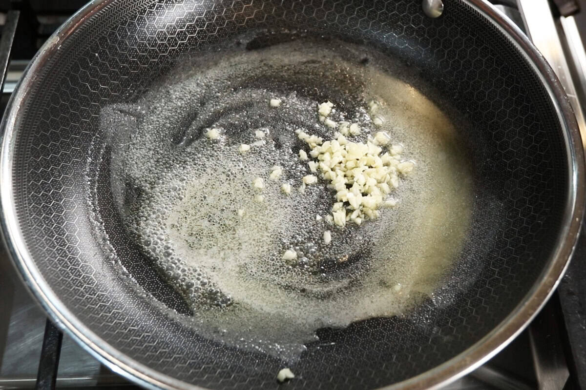 adding garlic to melted butter
