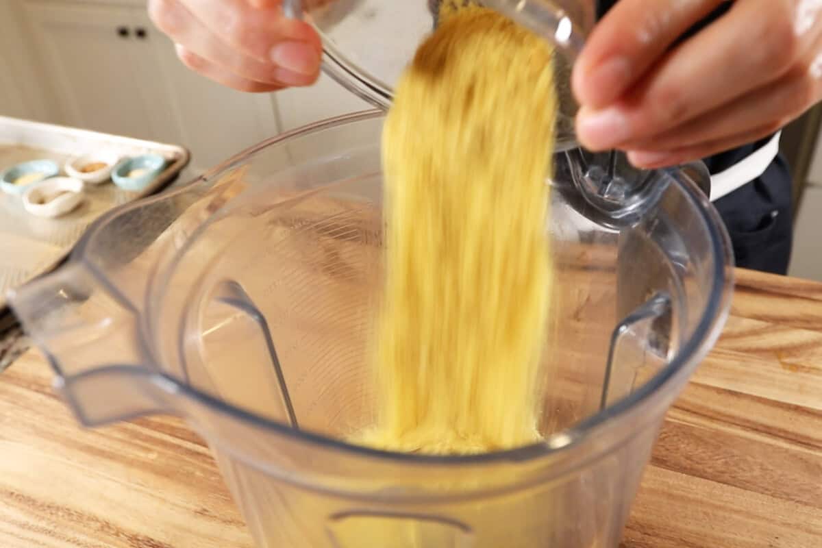 adding nutritional yeast to the blender