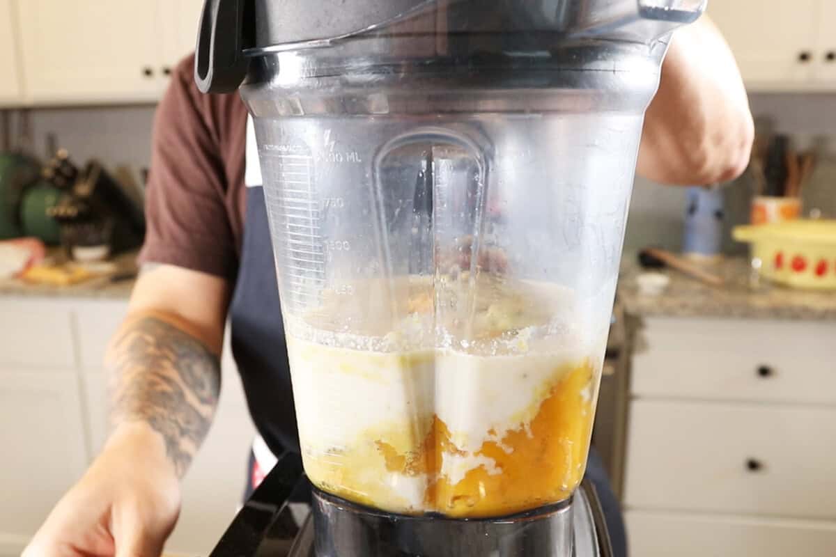 adding ingredients to a blender and starting to blend