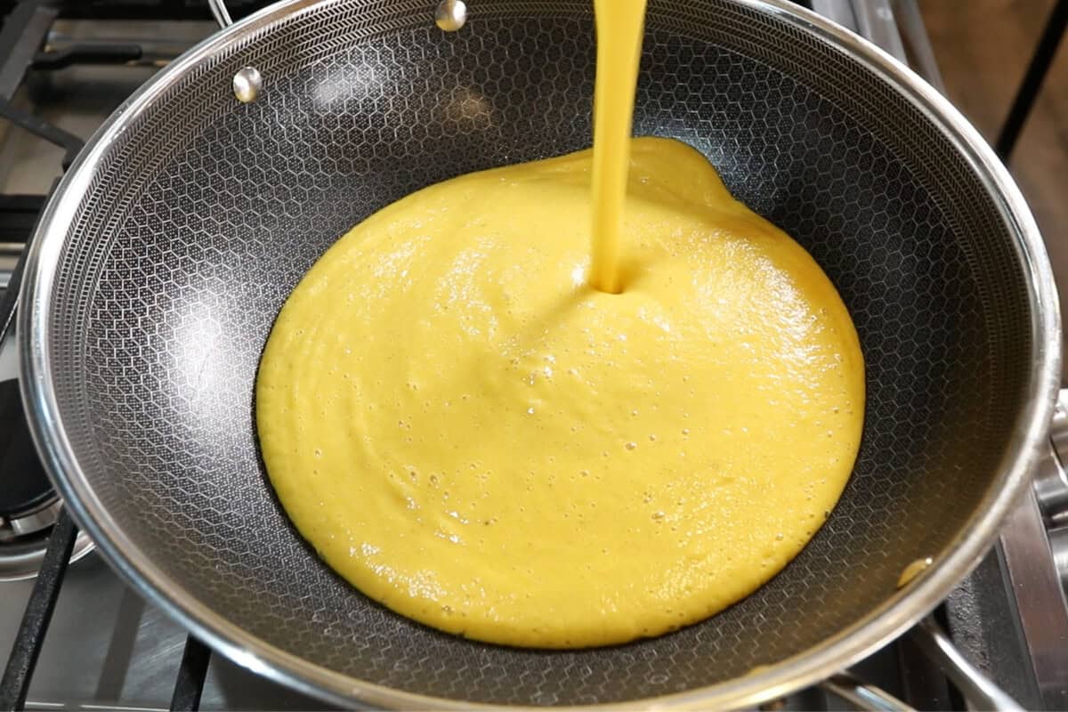 pouring sauce into a large skillet