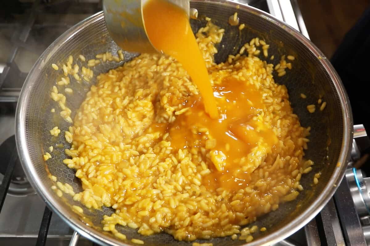 pouring in the butternut squash and broth mixture
