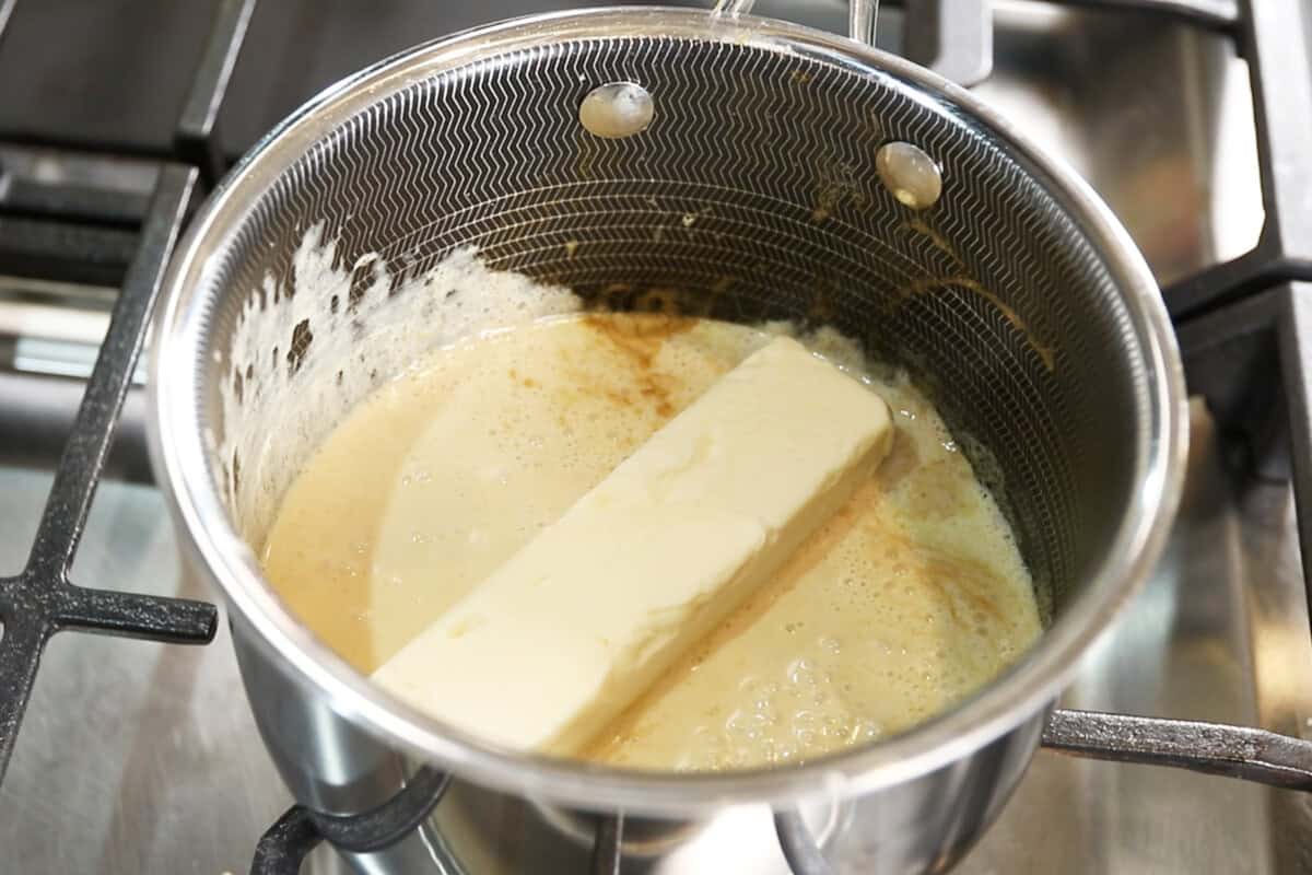 adding butter to saucepan