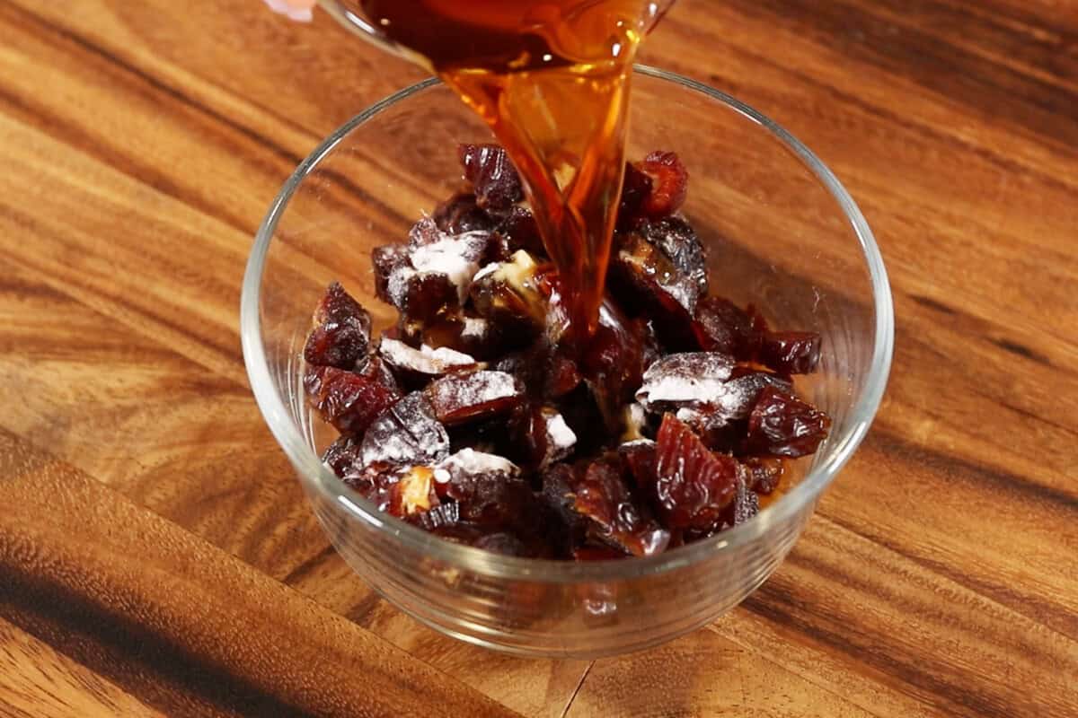 adding chai tea to bowl of dates