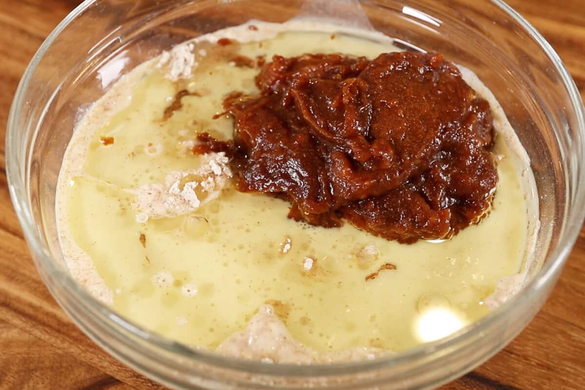 adding date paste mixture to bowl